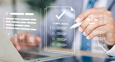person reviewing compliance documents with a laptop and checklist graphics in a modern office setting
