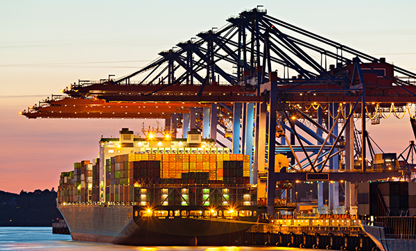 container ship docked at port with crane loading containers at sunset logistics shipping 4 industry